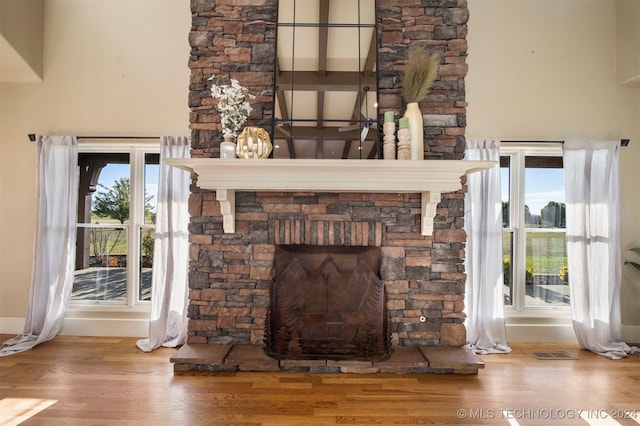 details featuring a stone fireplace and hardwood / wood-style floors