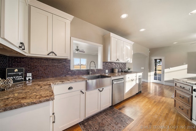 kitchen featuring stainless steel dishwasher, light hardwood / wood-style floors, white cabinetry, and sink