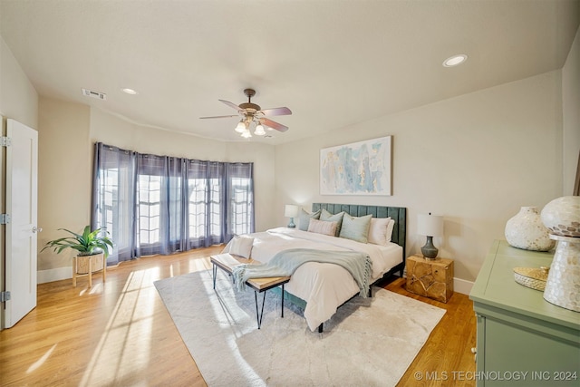 bedroom with ceiling fan and light wood-type flooring