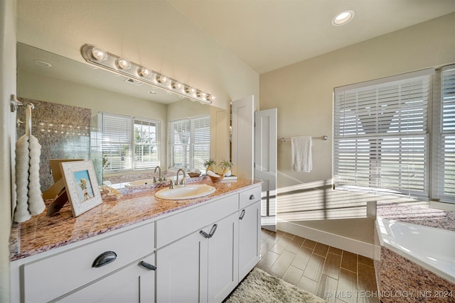 bathroom with vanity and tiled shower