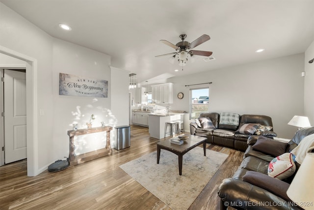 living room with hardwood / wood-style floors and ceiling fan