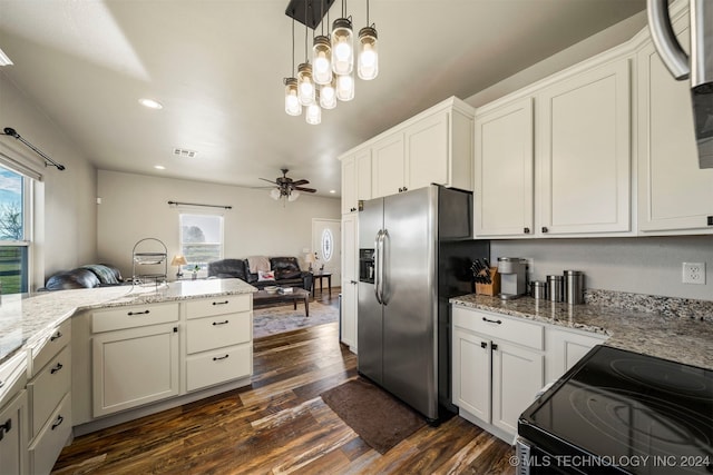 kitchen with dark hardwood / wood-style floors, ceiling fan with notable chandelier, a wealth of natural light, and black / electric stove