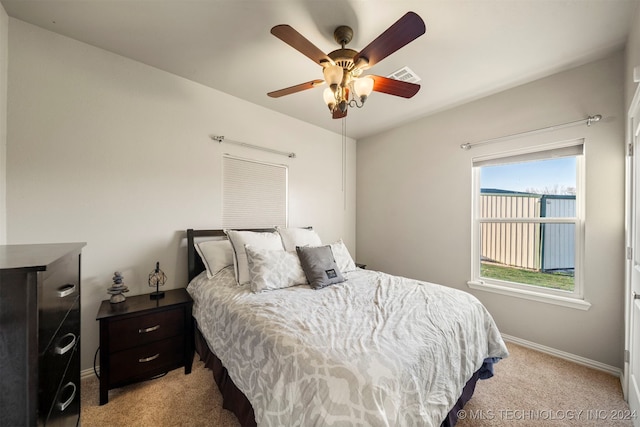 bedroom with ceiling fan and light carpet