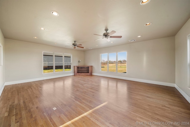 unfurnished living room with ceiling fan and wood-type flooring