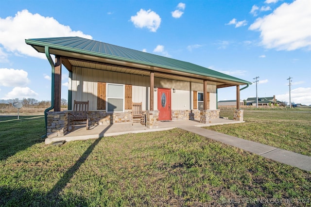 exterior space with a lawn and a porch