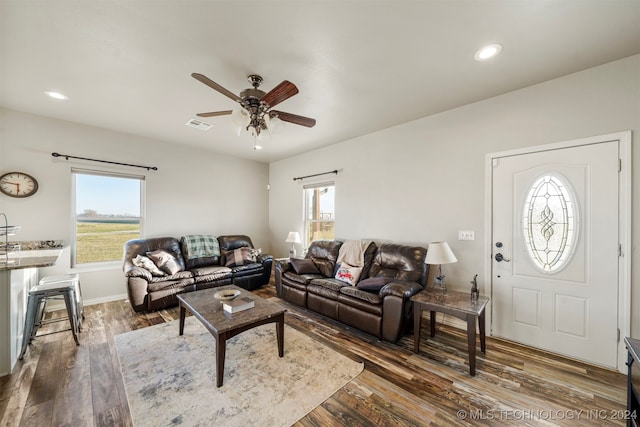 living room with ceiling fan, a healthy amount of sunlight, and dark hardwood / wood-style flooring