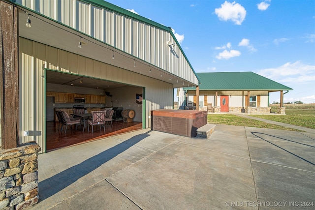 view of patio / terrace featuring a hot tub