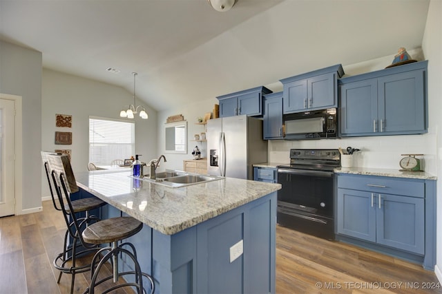 kitchen with sink, dark wood-type flooring, lofted ceiling, a kitchen island with sink, and black appliances