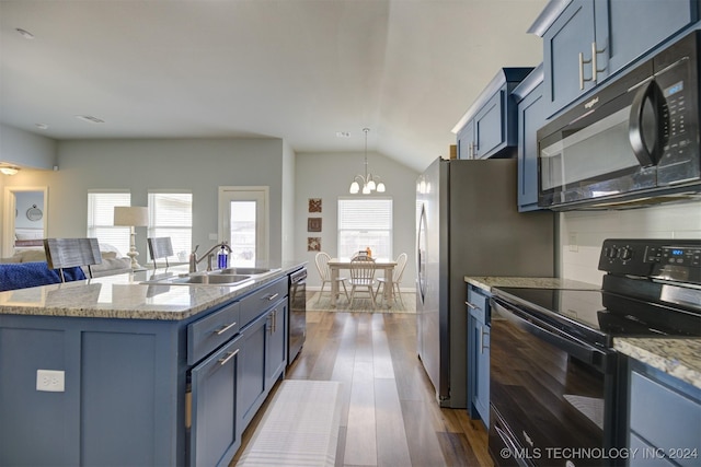 kitchen featuring sink, an island with sink, blue cabinets, and black appliances