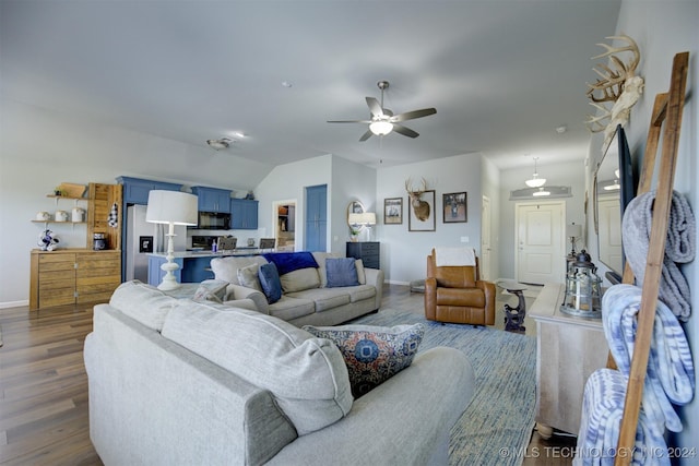 living room with ceiling fan, lofted ceiling, and dark wood-type flooring