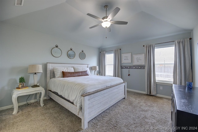 bedroom with carpet floors, vaulted ceiling, multiple windows, and ceiling fan