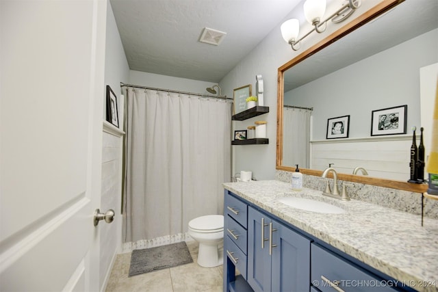 bathroom featuring tile patterned floors, a textured ceiling, vanity, toilet, and curtained shower