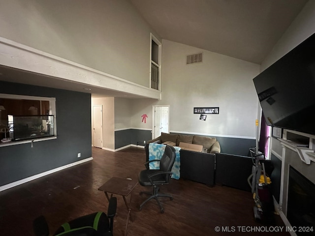 interior space featuring a fireplace, dark hardwood / wood-style floors, and vaulted ceiling