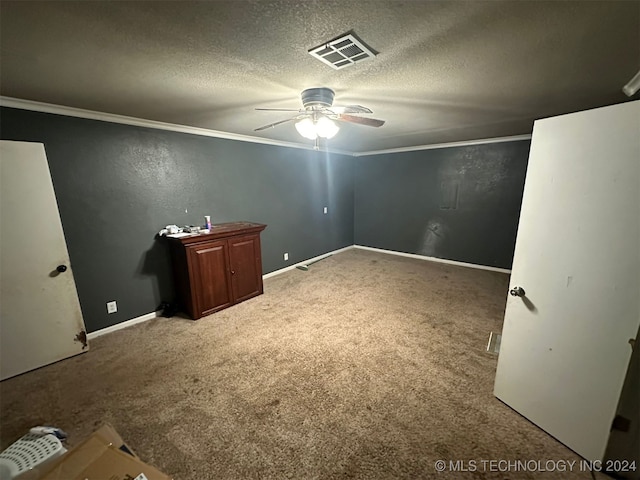 unfurnished bedroom with carpet, a textured ceiling, ceiling fan, and ornamental molding