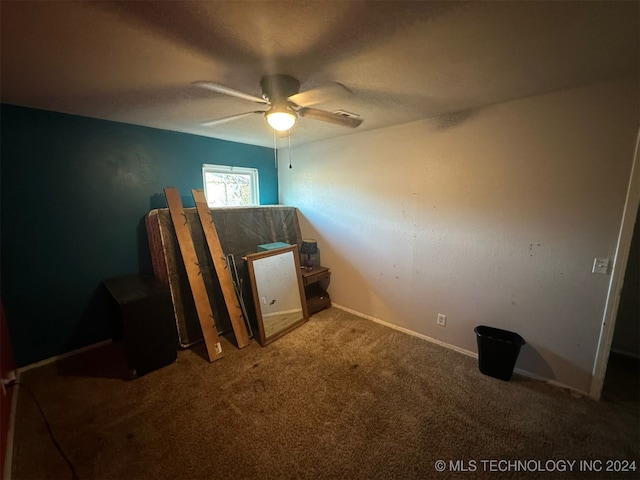 unfurnished bedroom featuring carpet and ceiling fan