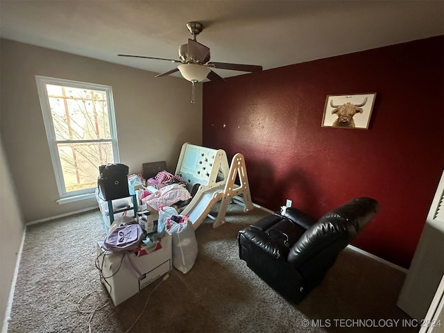 interior space with ceiling fan and carpet floors