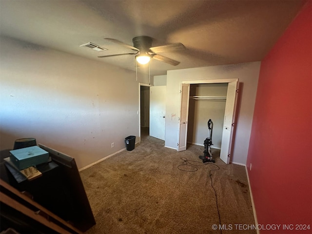 unfurnished bedroom featuring carpet, ceiling fan, and a closet