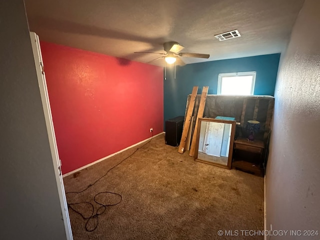 unfurnished bedroom with ceiling fan and carpet floors