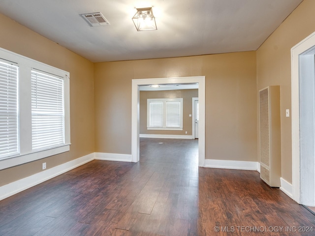 unfurnished room with dark hardwood / wood-style floors