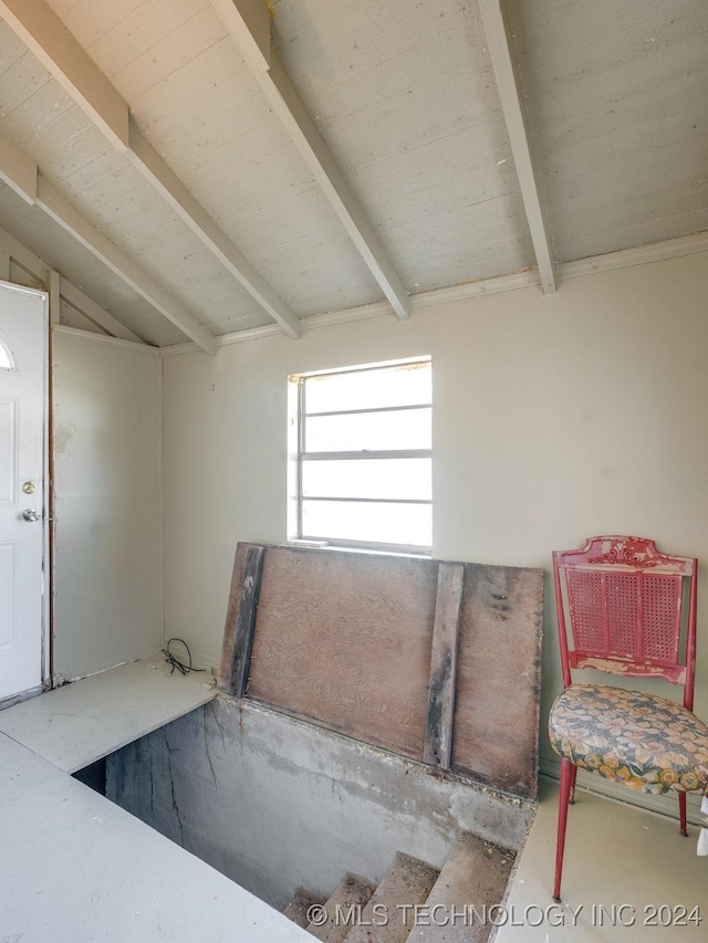 interior space featuring lofted ceiling with beams