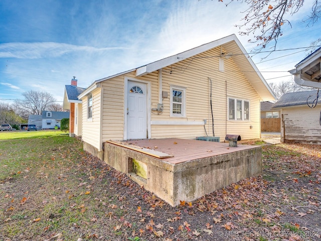 back of house featuring a wooden deck