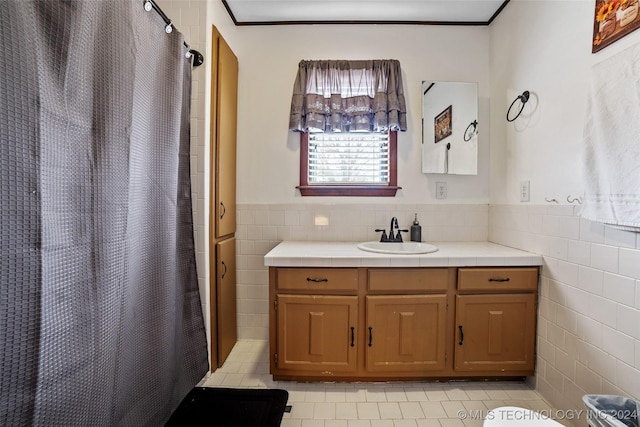 bathroom featuring walk in shower, vanity, toilet, and tile walls