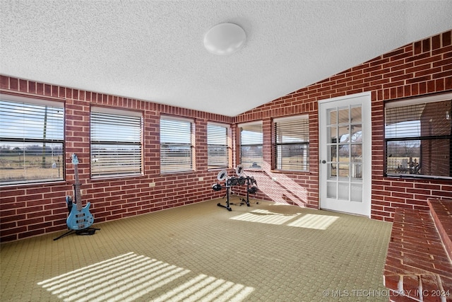 unfurnished sunroom with lofted ceiling