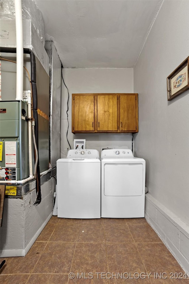 laundry room featuring cabinets and washer and dryer