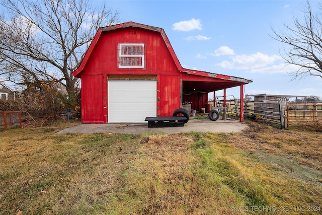 view of outdoor structure with a garage and a lawn