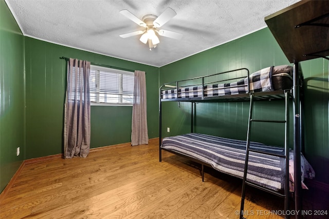 bedroom with light hardwood / wood-style flooring and ceiling fan