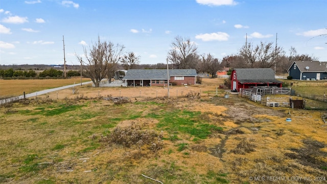 view of yard featuring an outdoor structure and a rural view