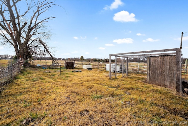 view of yard featuring an outbuilding and a rural view