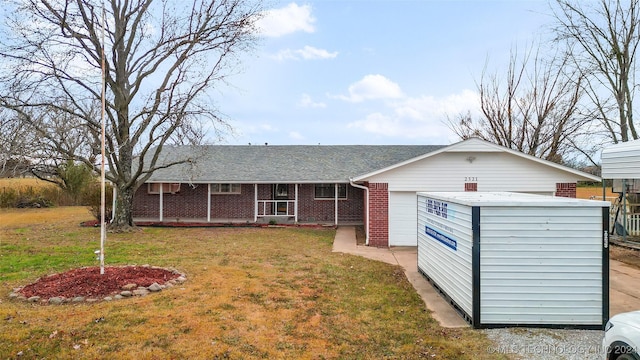 single story home with a garage, a front lawn, and a porch