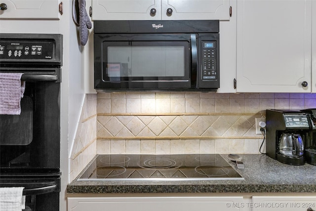 kitchen with tasteful backsplash, white cabinetry, and black appliances