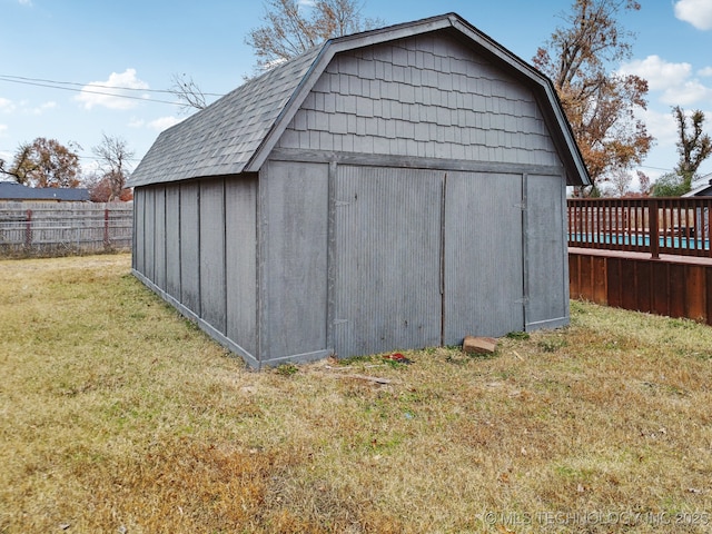 view of outbuilding featuring a lawn