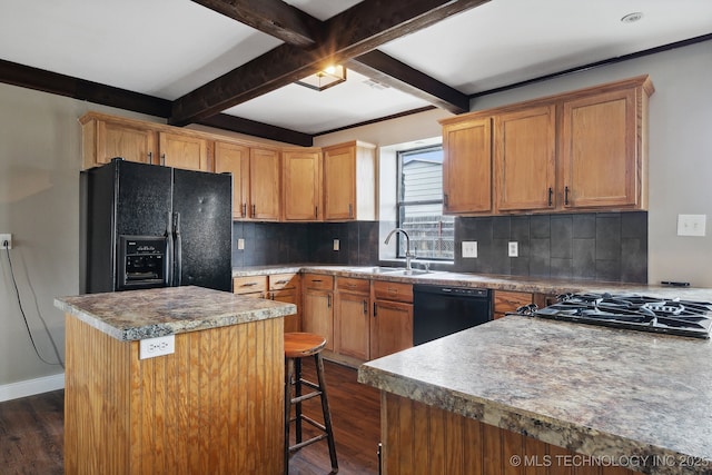 kitchen featuring a center island, sink, beam ceiling, and black appliances