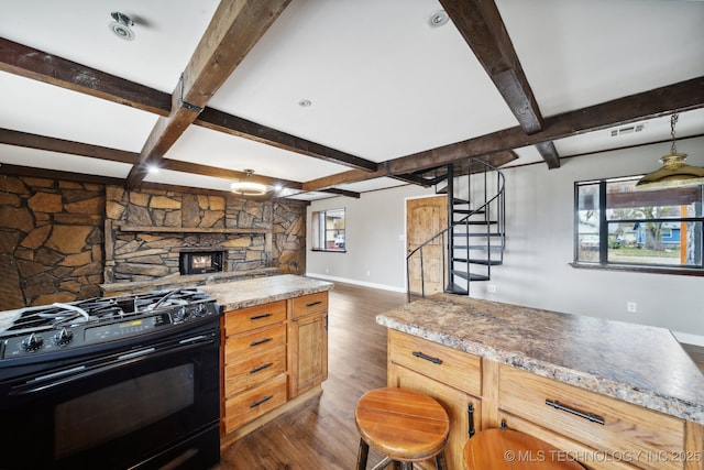 kitchen featuring beamed ceiling, black range with gas stovetop, and dark hardwood / wood-style floors