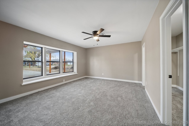 empty room featuring carpet and ceiling fan