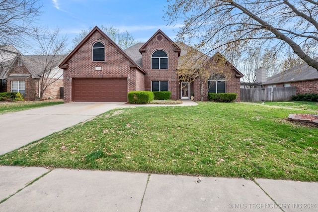 view of front of house featuring a garage and a front lawn