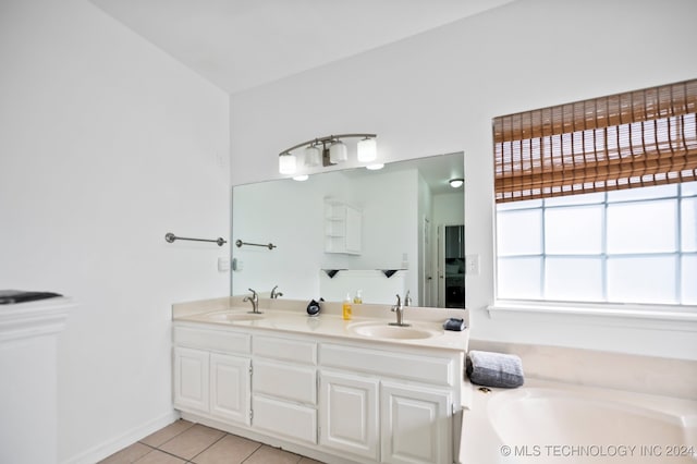 bathroom with tile patterned floors, vanity, and a bathing tub