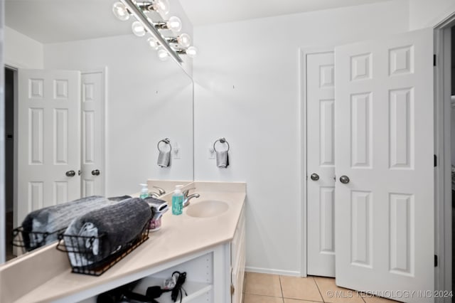 bathroom featuring tile patterned flooring and vanity