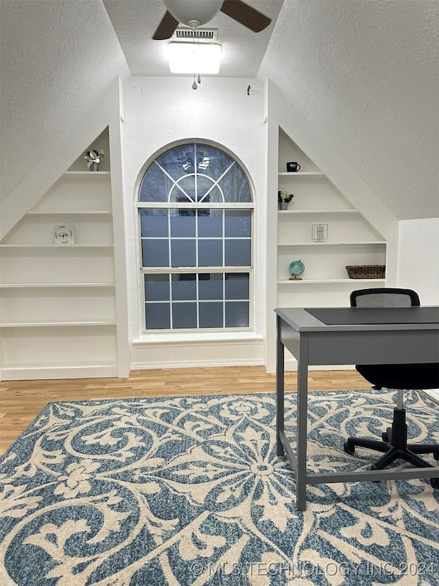 entryway featuring hardwood / wood-style flooring, ceiling fan, a textured ceiling, and vaulted ceiling