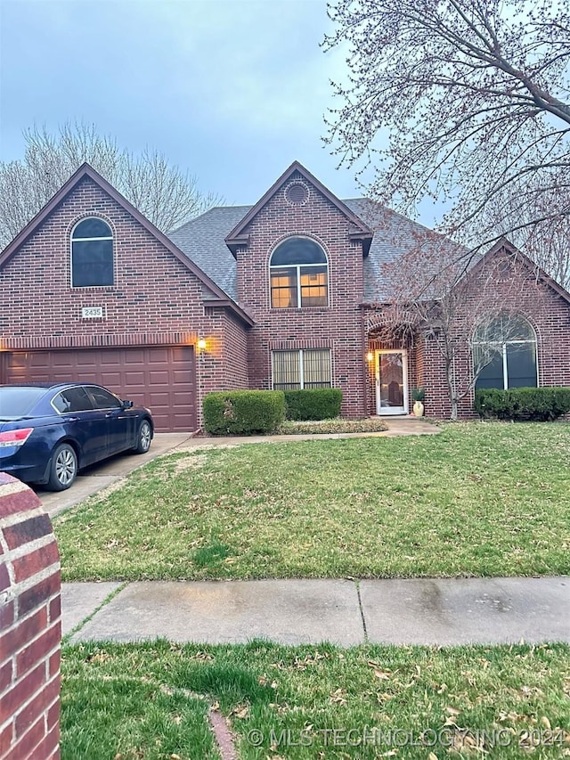 view of property with a front lawn and a garage