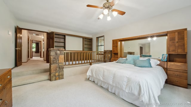 bedroom featuring ceiling fan and light colored carpet