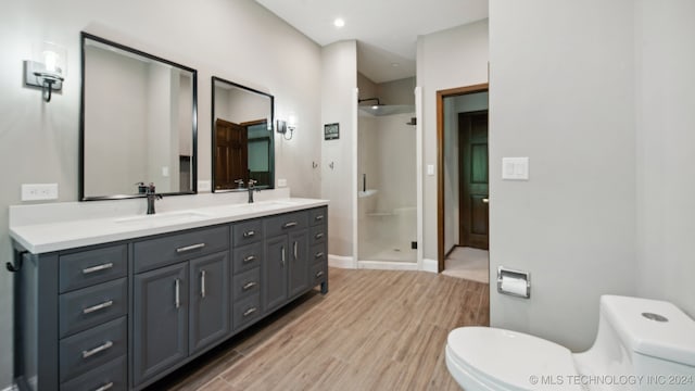 bathroom with vanity, hardwood / wood-style flooring, toilet, and walk in shower