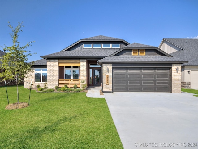 view of front of house featuring a front yard and a garage