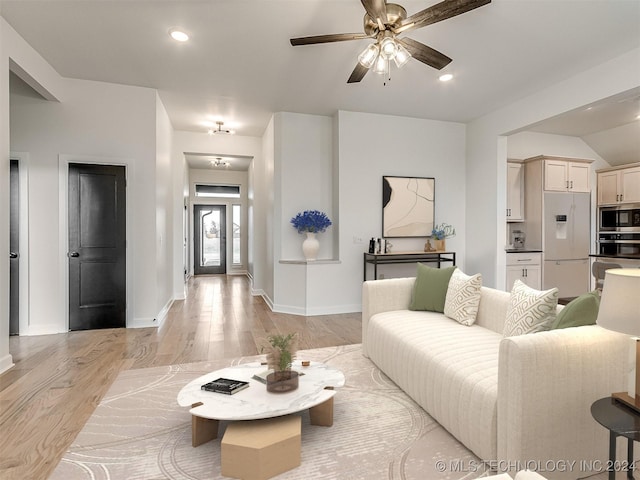 living room with ceiling fan and light hardwood / wood-style flooring