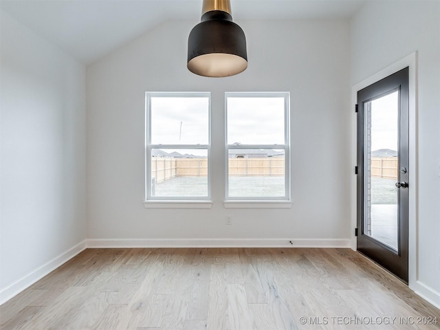 unfurnished dining area with a wealth of natural light, light hardwood / wood-style floors, and lofted ceiling