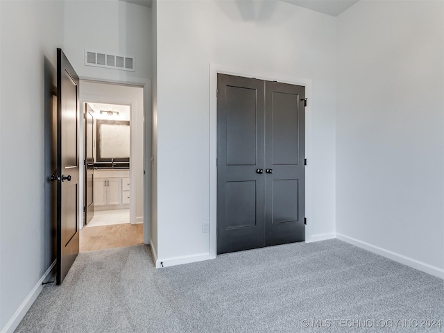 unfurnished bedroom featuring light carpet