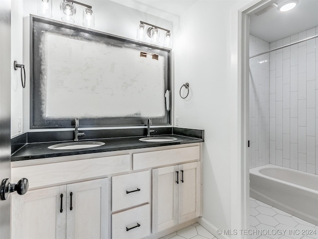 bathroom featuring tile patterned floors, vanity, and tiled shower / bath combo